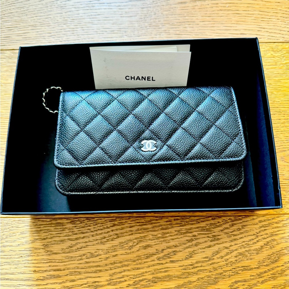 CHANEL Caviar Quilted Wallet on Chain WOC in black.